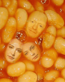 a bunch of baked beans with a man and two women 's faces in them