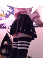 a person wearing knee high socks and a black pleated skirt with crosses on it