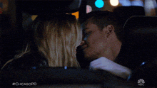 a man and a woman kissing in a car with #chicagopd written on the bottom