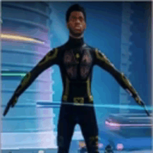 a man in a black and gold superhero suit is standing in a room .