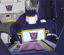 a transformer sitting at a desk with a purple emblem on it