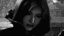 a black and white photo of a woman with a hood on