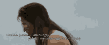 a man with long hair is talking about being hungry .