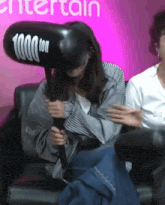 a woman is holding an inflatable hammer that says 1000 ton on it