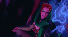 a woman with red hair and green scarf around her head