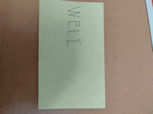 a yellow piece of paper that says well on it