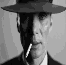 a man in a hat is smoking a cigarette in his mouth .