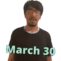 a man wearing glasses and a black shirt that says march 30 on it