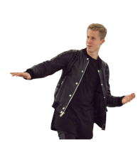 a man wearing a black jacket and a black shirt is dancing