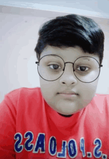 a boy wearing glasses and a red shirt that says 22a0j09.2