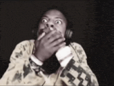 a man wearing headphones is making a funny face