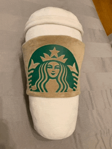 a starbucks cup shaped pillow with a starbucks logo