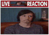 a man is sitting in front of a sign that says " live reaction "