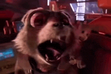 a cartoon dog with its mouth open is standing next to a toy mouse .