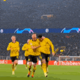 a group of soccer players are running on a field in front of a banner that says ' huisbet '