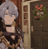 a man stands in front of a door with a wreath on it and the number 671 on it