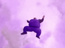 a man is doing a handstand in the air while flying through the clouds .