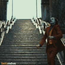 a man in a suit is running down a set of stairs