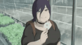 a woman with purple hair is holding a dandelion in her hand .