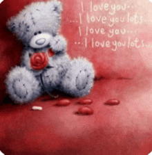 a teddy bear is sitting on a red heart with the words " i love you " written on the bottom