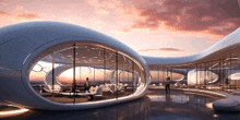 an artist 's impression of a futuristic building with a sunset behind it