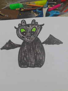 a child 's drawing of a bat with green eyes