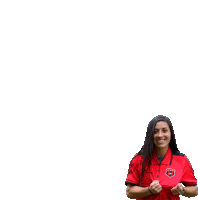 a woman wearing a red shirt with a fc logo on it