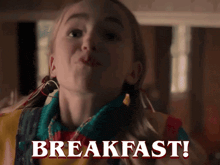 a young girl is making a face and the words breakfast are behind her