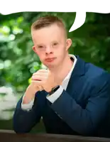 a man with down syndrome wearing a blue suit