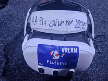 a virtual reality headset has a blue sticker that says plutusvr