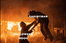 a man is being lifted in the air by another man with the words christmas halloween and mood on the bottom