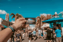 a person holds up a universal orlando resort ticket