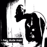 a black and white image of a man with a sign that says i 'm a dude man on it
