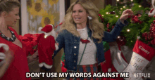 a woman is holding a stuffed santa and says " don t use my words against me "