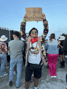 a man holds a sign that says yo vine x rosa paste