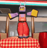 a cartoon character is standing on a checkered table cloth .