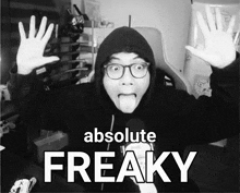 a black and white photo of a man with his tongue out and the words absolute freaky behind him