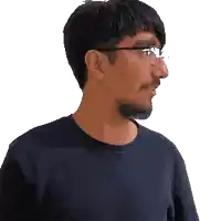 a man wearing glasses and a black shirt is clapping his hands