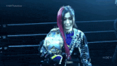 a woman with red hair is holding a world heavyweight championship belt .