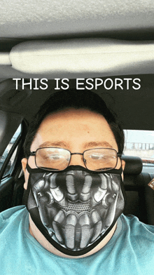 a man wearing glasses and a mask that says this is esports on it