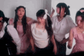 a group of young women are standing next to each other in a room .