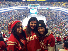 three girls wearing red boston sweatshirts are posing for a picture