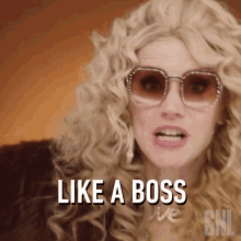 a woman wearing sunglasses and a fur coat says " like a boss "