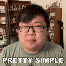 a man with glasses says pretty simple in front of a bookshelf