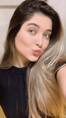 a woman with long hair is making a funny face with her lips