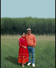 a man and woman standing in a field with trees in the background and the words happy anniversary on the bottom