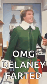 a man in a green elf costume is standing in a room and says `` omg delaney farted '' .
