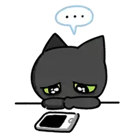 a black cat with green eyes is laying down next to a cell phone