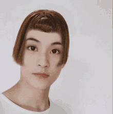 a woman with a very short haircut has a fringe on her forehead