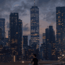 a man in a black shirt stands in front of a city skyline at dusk